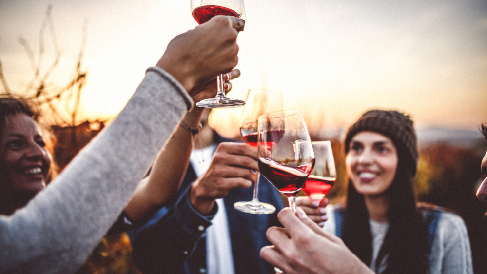 a woman drinking from a wine glass