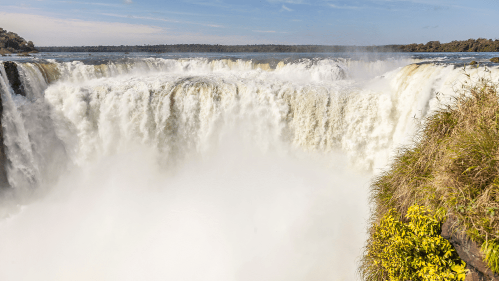 a large waterfall coming out of the water